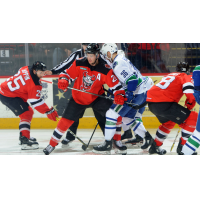 Binghamton Devils Center Kevin Rooney holds off the Utica Comets