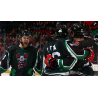 Binghamton Devils celebrate a goal in St. Patrick's jerseys