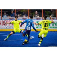 Milwaukee Wave defender Marcio Leite and forward Isaac Pereyra defend against the Kansas City Comets