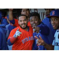 Rene Rivera celebrates in the Syracuse Mets dugout with his teammates after his first-inning home run on Friday night